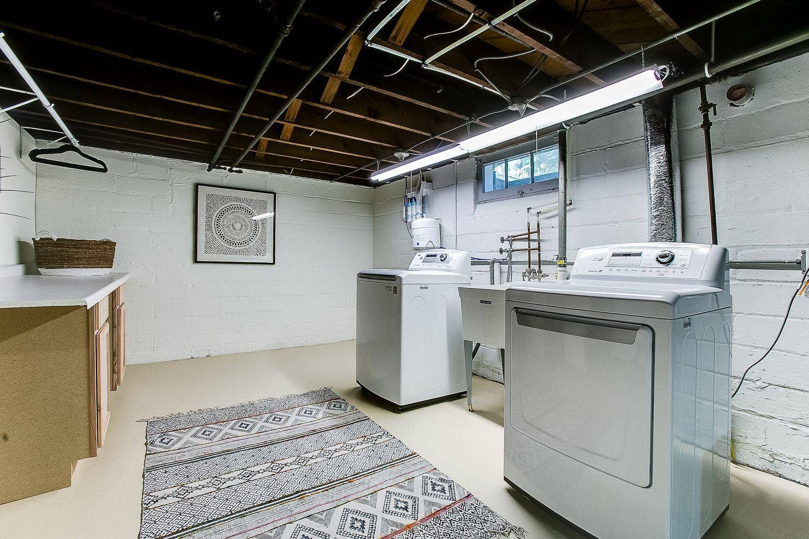 Basement laundry area virtually staged