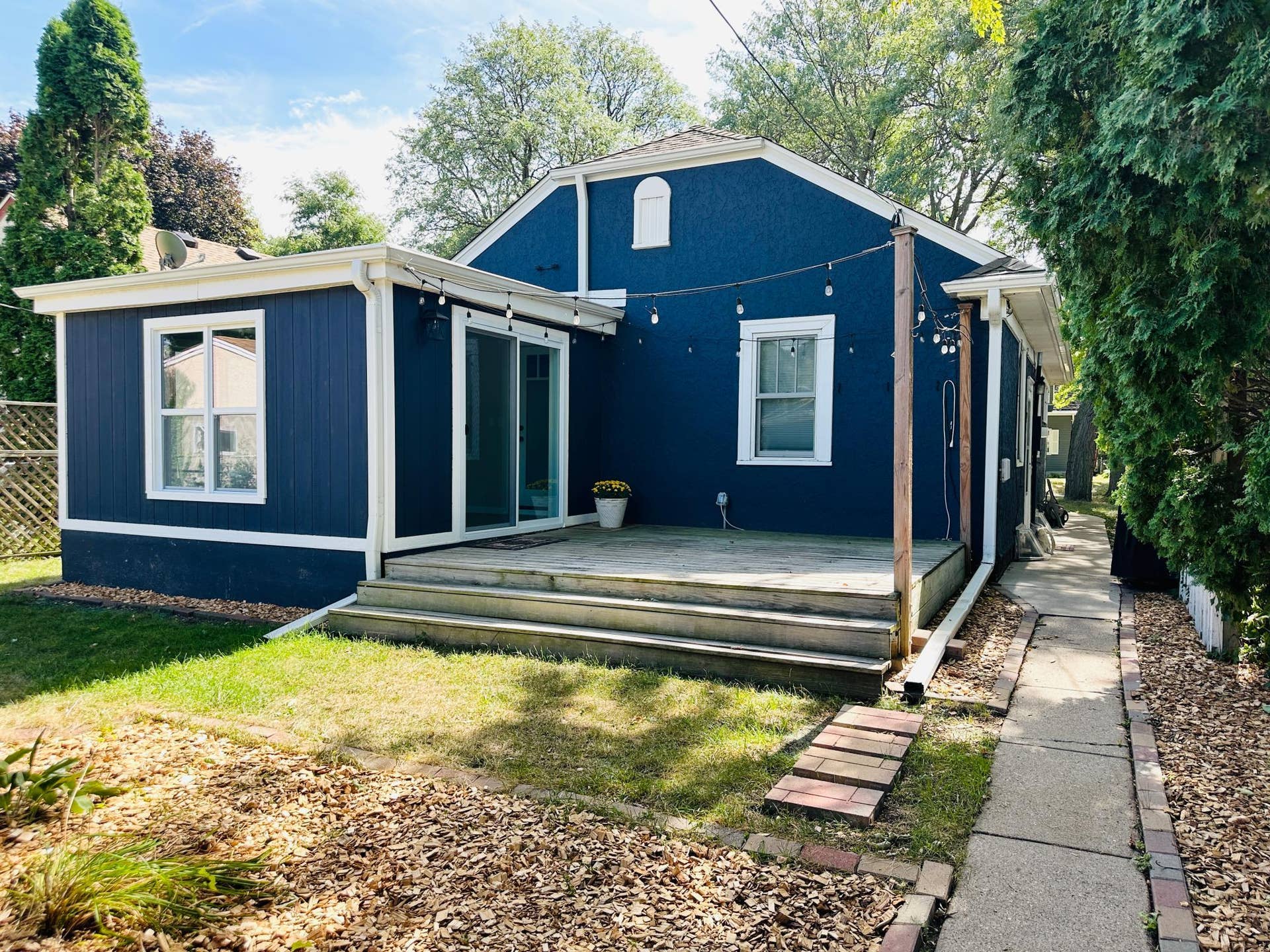 Backyard and deck next to sunroom