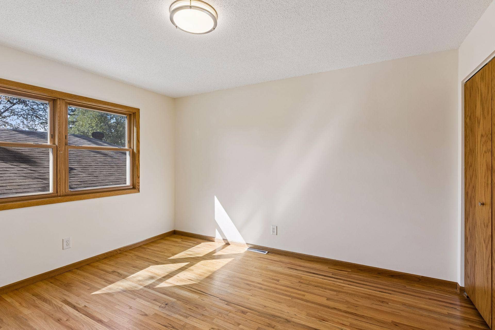 2215 Lincoln Street NE, 87, Minneapolis, MN 55418 Main floor bedroom 1 with large window and natural hardwood floor floors