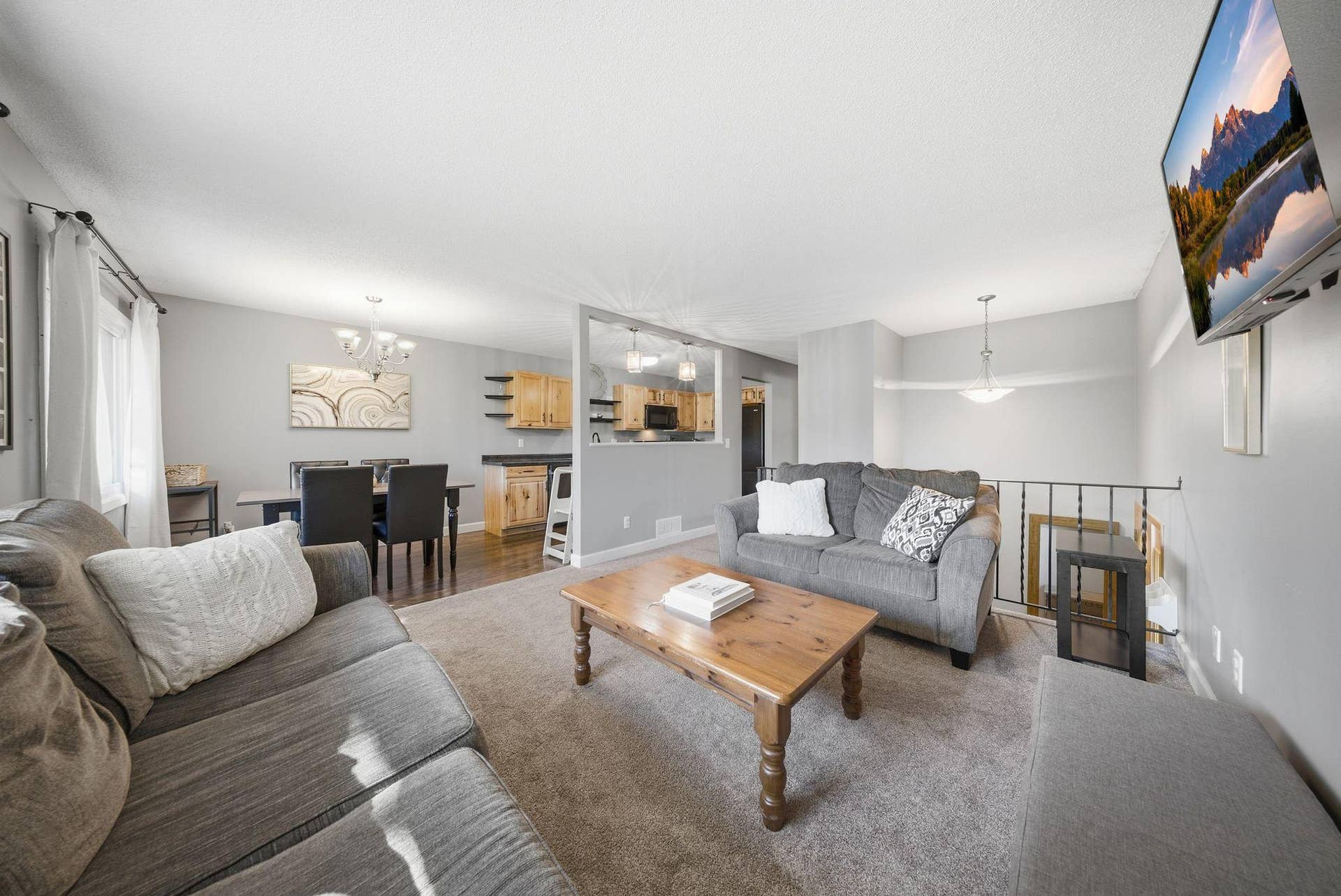 3610 Avon Court, Woodbury, MN 55125 The spacious kitchen features beautiful wood cabinetry, ample cabinet and counter space, a newer dishwasher, and a pass-through to the living room that opens up the main level and creates a more connected feel.