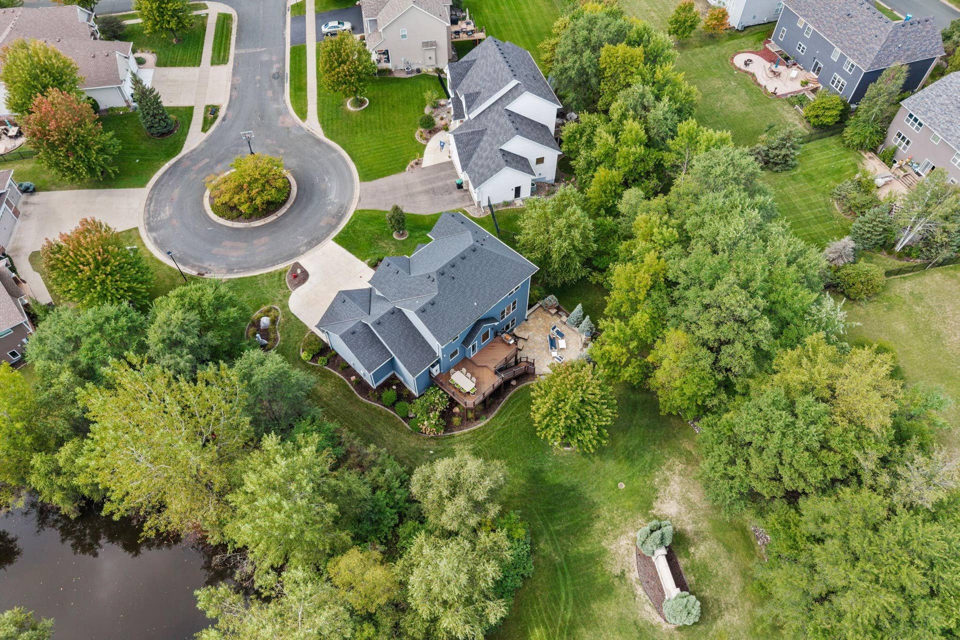 17550 73rd Avenue N, Maple Grove, MN 55311 A peaceful pond adds another beautiful natural element to the backyard setting.