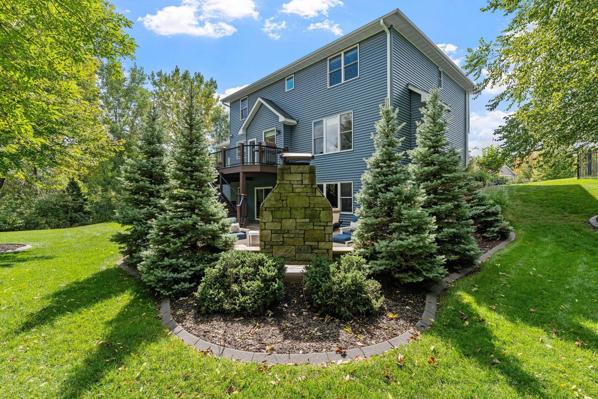 17550 73rd Avenue N, Maple Grove, MN 55311 Upgraded landscaping enhances the homes curb appeal and beautifully complements the spacious, mature setting.
