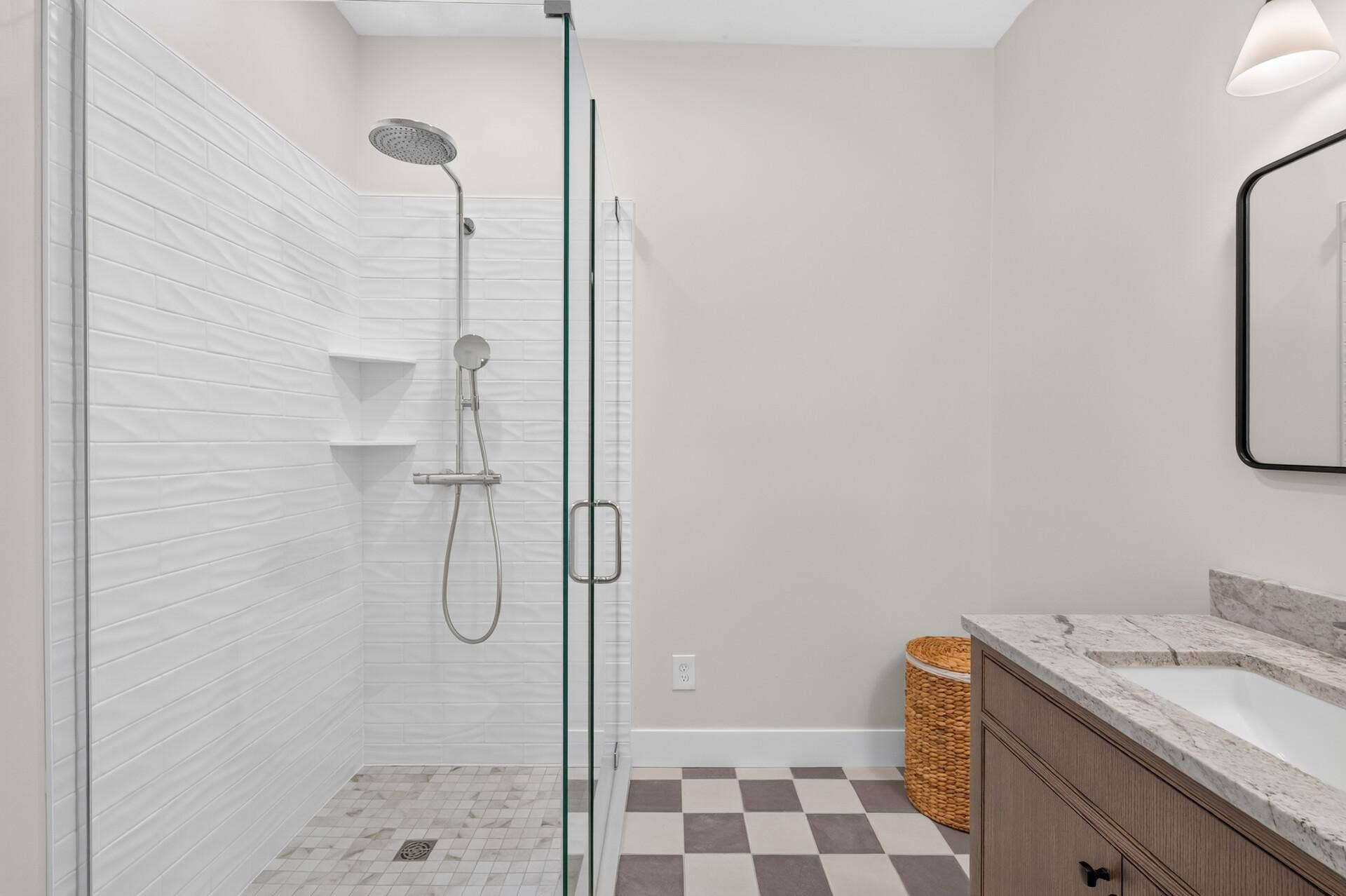 1835 Stillwater Street, White Bear Lake, MN 55110 Upscale primary bath addition featuring a custom-tiled shower, classic checkerboard tile floor, and new vanity.