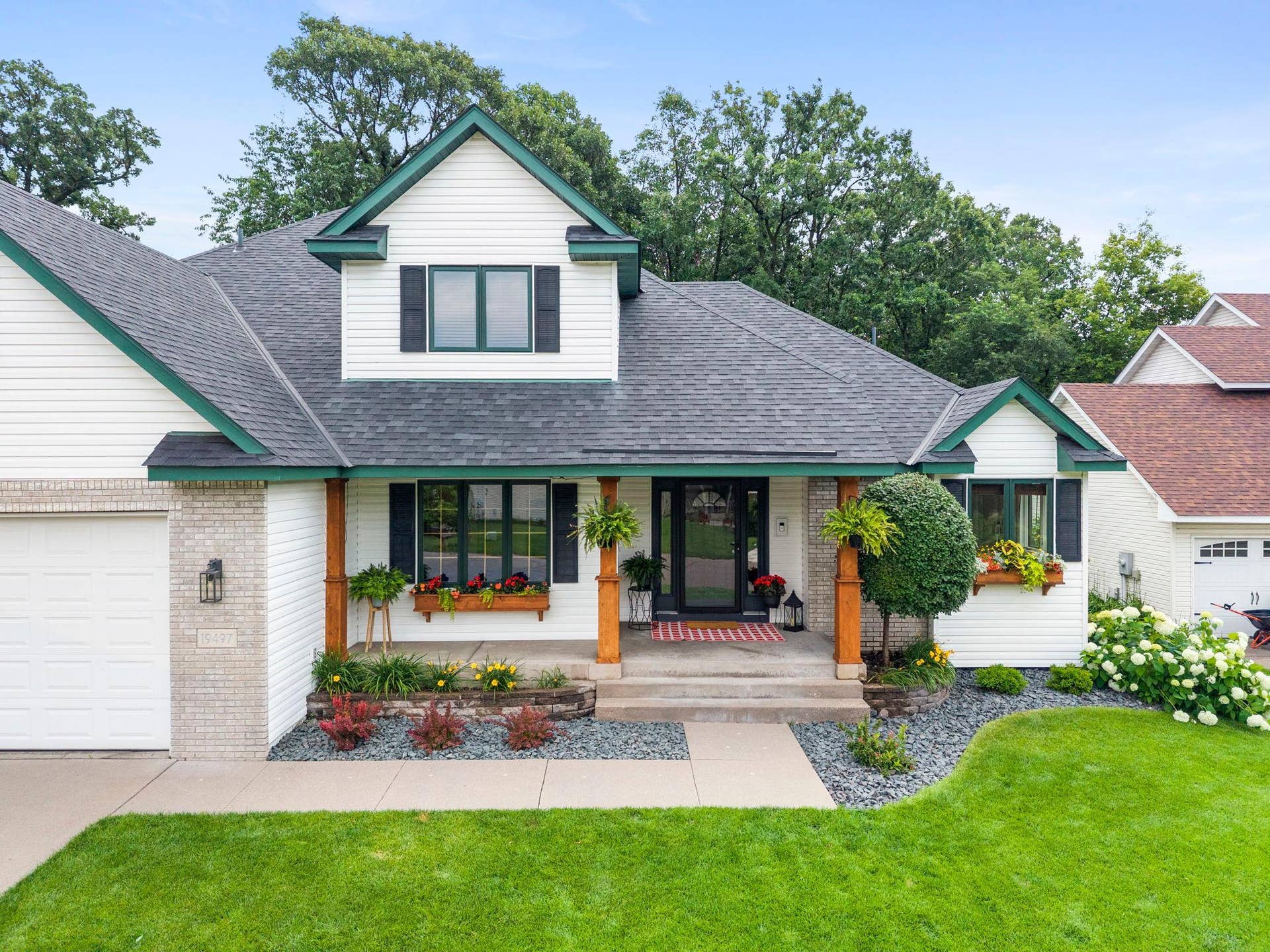 19497 Boston Street NW, Elk River, MN 55330 A beautifully landscaped yard shows pride of ownership.
