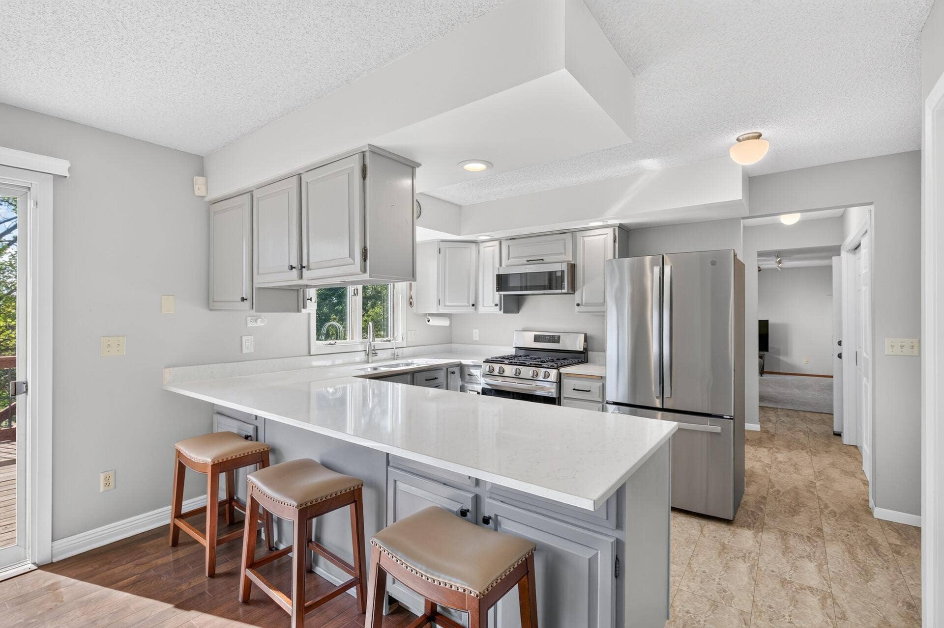 4315 Kaufmanis Way, Eagan, MN 55123 Updated kitchen features painted cabinetry, expansive quartz countertops, stainless steel appliances and a large center island with seating. Countertops and appliances were replaced in 2022.