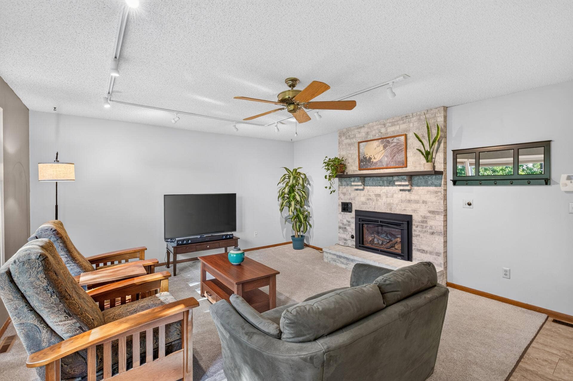 4315 Kaufmanis Way, Eagan, MN 55123 Spacious family room offers a comfortable gathering space centered around a brick fireplace with a raised hearth and abundant natural light