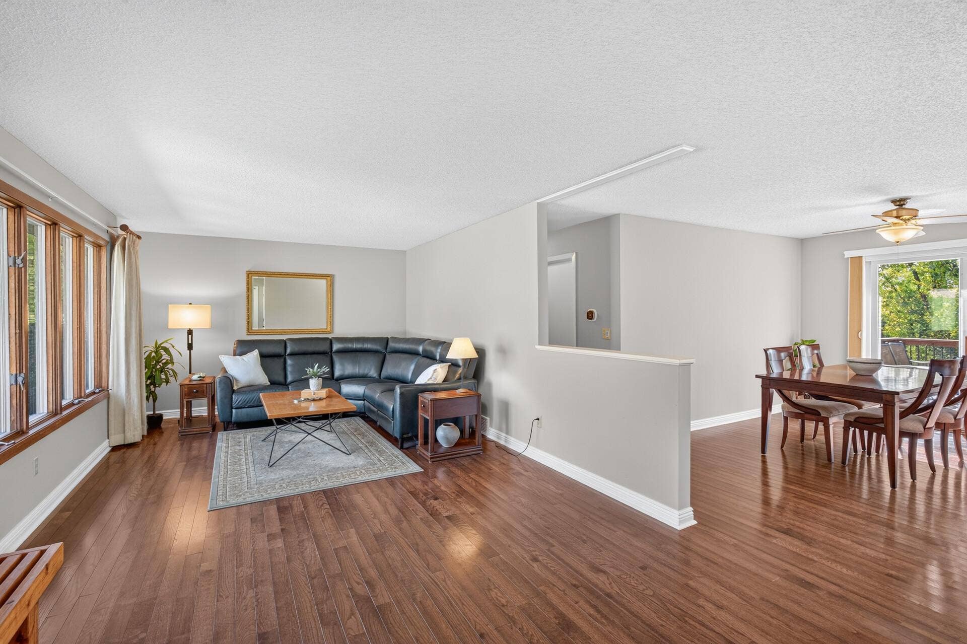 4315 Kaufmanis Way, Eagan, MN 55123 Open-concept living and dining spaces feature newer hardwood floors and a wall of windows