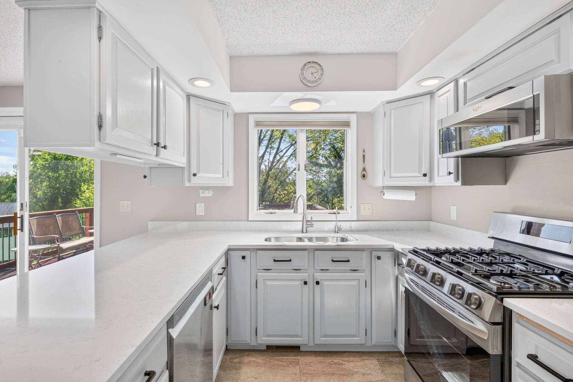 4315 Kaufmanis Way, Eagan, MN 55123 Bright and functional kitchen offers abundant cabinetry, generous prep space and a large window overlooking the backyard and surrounding mature trees