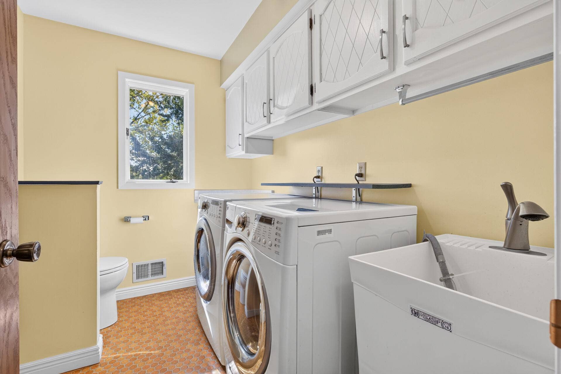 4315 Kaufmanis Way, Eagan, MN 55123 Main floor laundry room offers cabinetry, laundry sink, and a toilet too. All living facilities are on the main level
