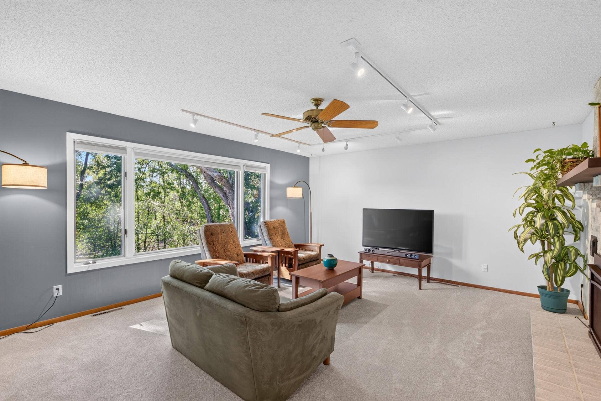 4315 Kaufmanis Way, Eagan, MN 55123 Large windows bring the outdoors in and a brick fireplace creates a warm focal point for relaxing and gathering