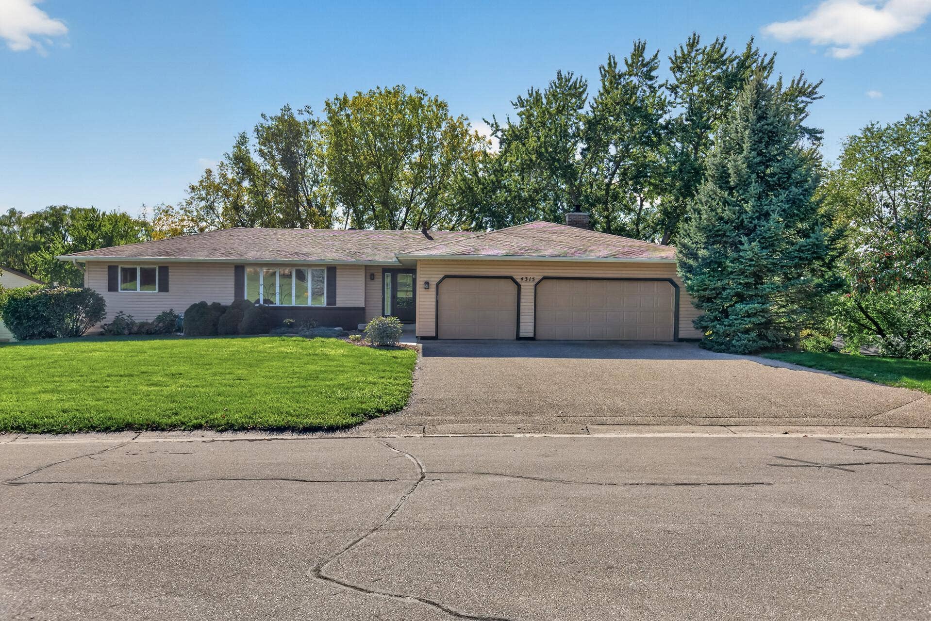 4315 Kaufmanis Way, Eagan, MN 55123 Classic rambler design with a spacious 3-car garage, brand new front door, and beautifully maintained lawn and landscaping