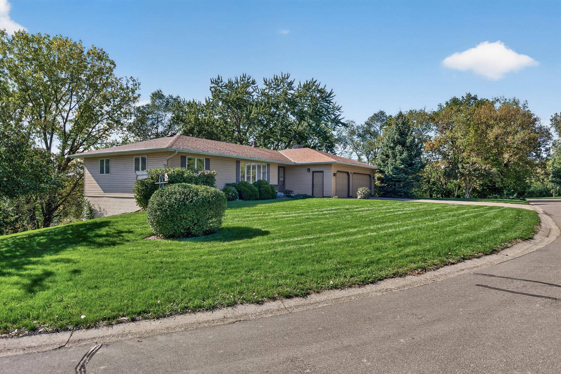 4315 Kaufmanis Way, Eagan, MN 55123 Expansive .5-acre corner lot offers a generous setting for this well-maintained 2,742 SF rambler, surrounded by mature trees and established landscaping.