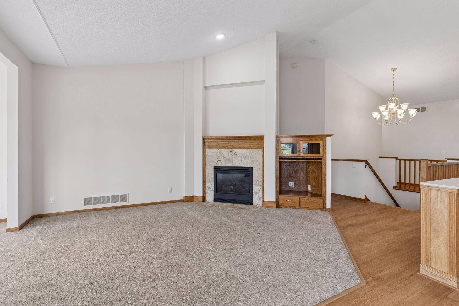 Main level living area is centered by a cozy fireplace