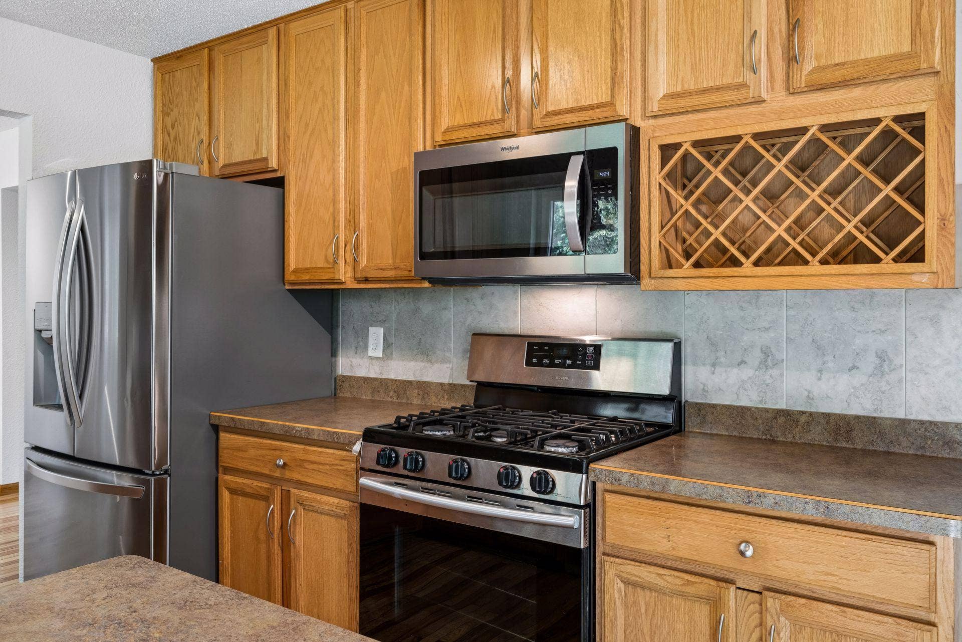 2841 Riviera Drive N, White Bear Lake, MN 55110 Gas range, stainless steel refrigerator and microwave, and built-in wine storage.