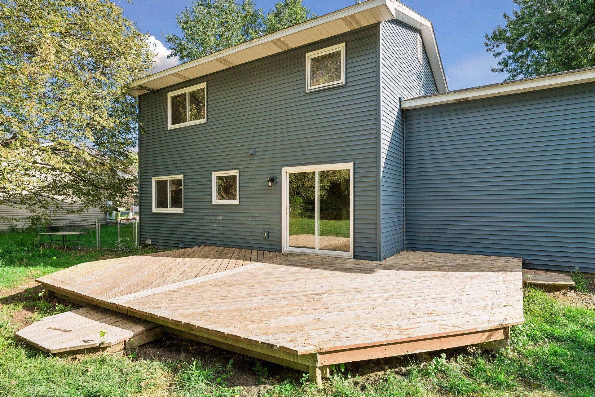 2841 Riviera Drive N, White Bear Lake, MN 55110 Rear exterior showing the deck and sliding-door access to the kitchen.