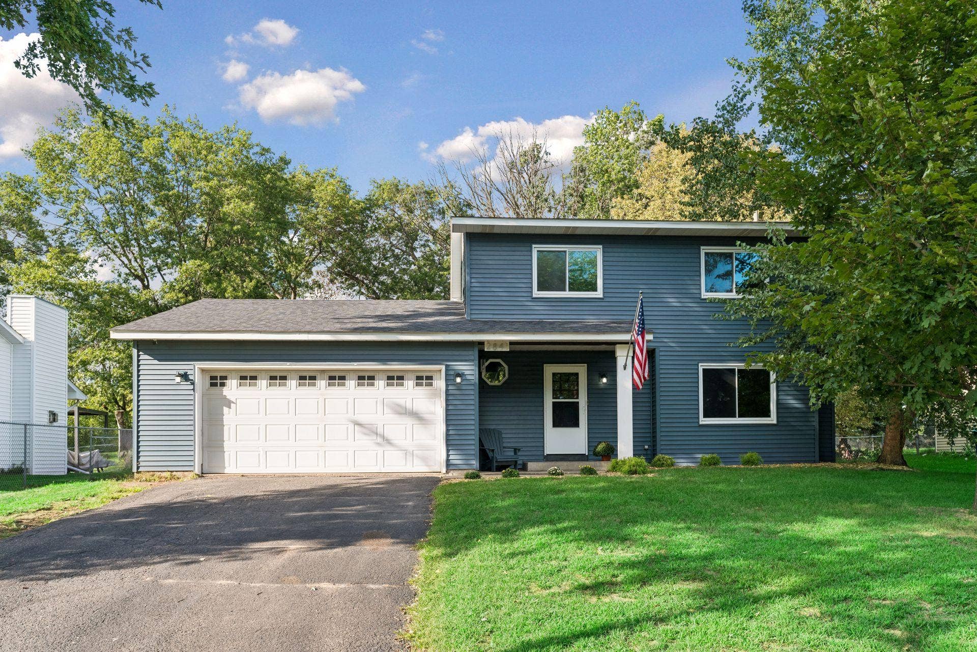 2841 Riviera Drive N, White Bear Lake, MN 55110 Blue vinyl siding, white trim, and mature trees frame the front exterior.