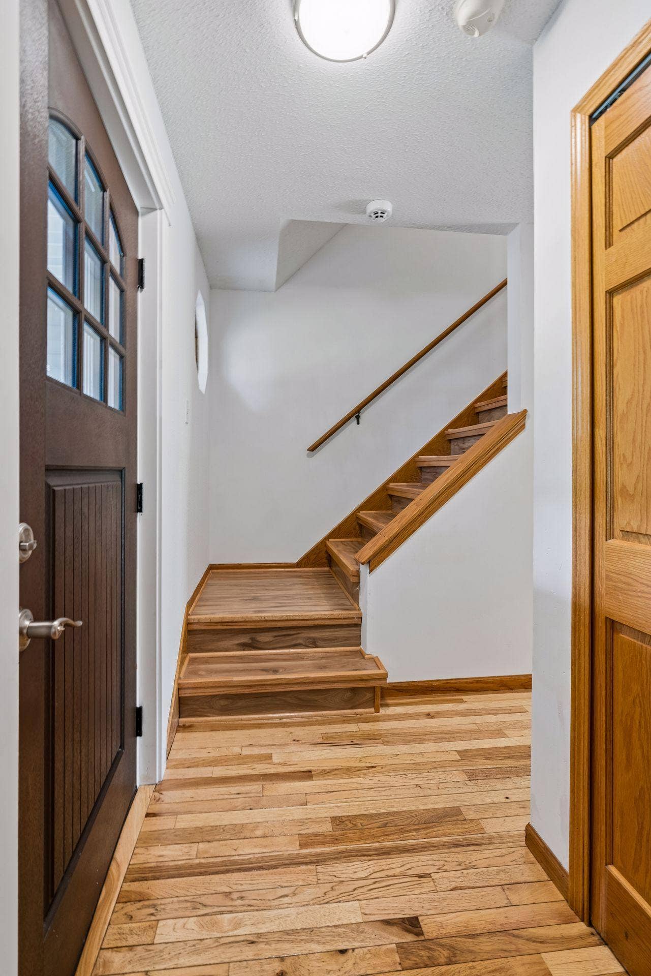 2841 Riviera Drive N, White Bear Lake, MN 55110 Hardwood stairs lead to the upper level, where all three bedrooms are located.