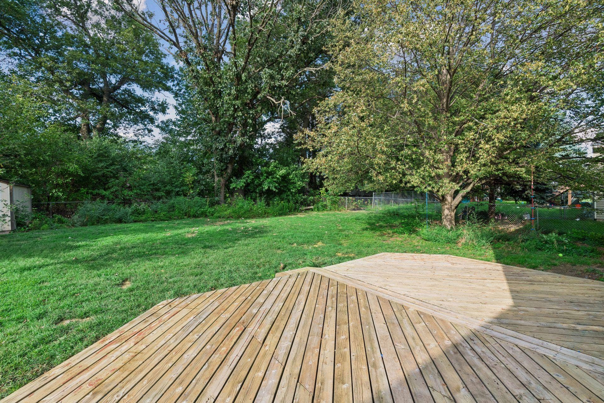 2841 Riviera Drive N, White Bear Lake, MN 55110 Spacious backyard deck overlooks the lawn and mature trees.