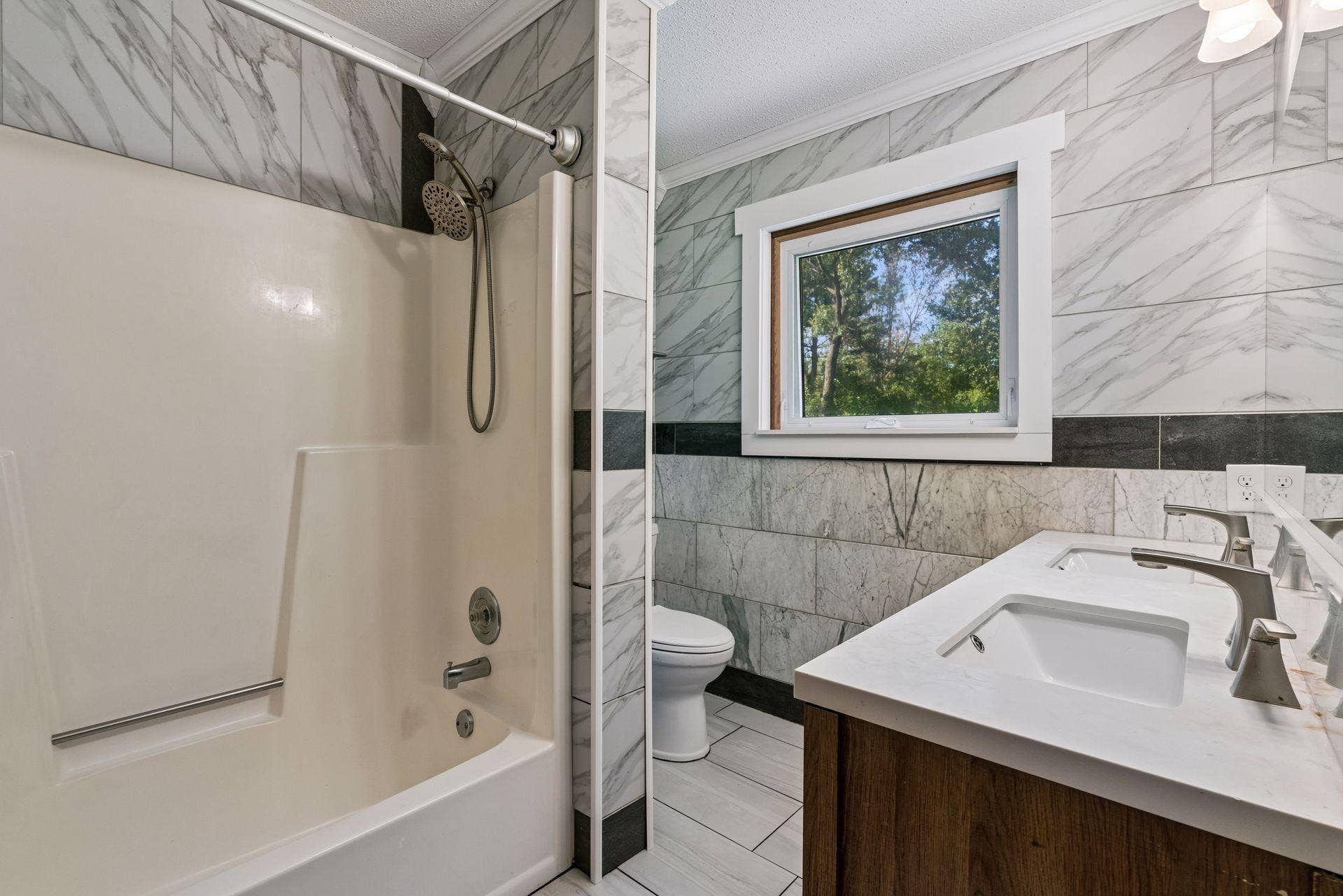 2841 Riviera Drive N, White Bear Lake, MN 55110 Full bathroom with a tub/shower combination, tile finishes, and a double-sink vanity.