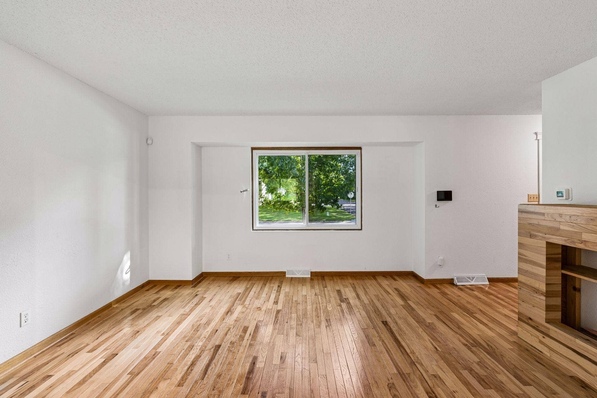 2841 Riviera Drive N, White Bear Lake, MN 55110 Large living room window overlooks the front yard and mature trees.