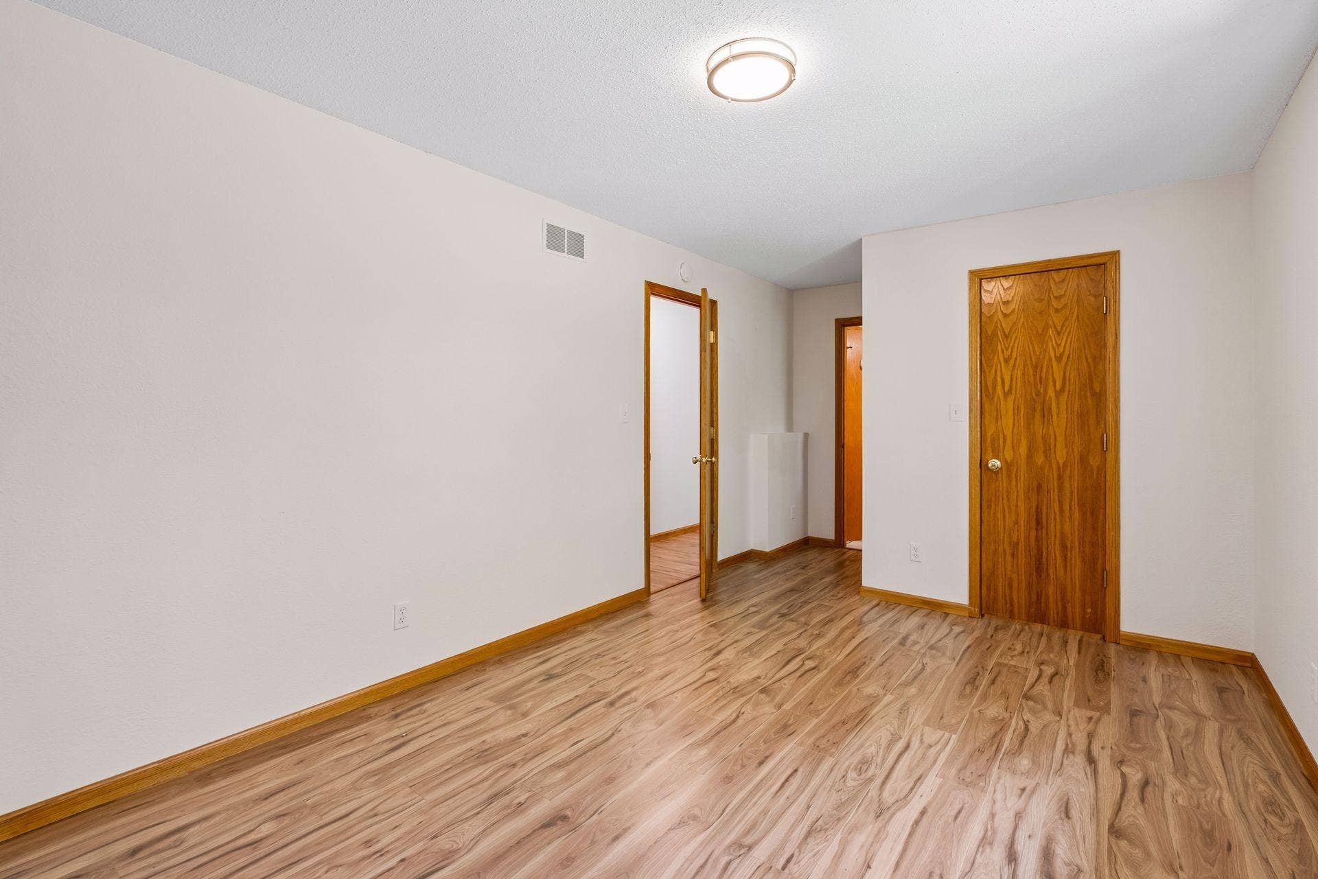 2841 Riviera Drive N, White Bear Lake, MN 55110 Alternate view of the primary bedroom and its hardwood flooring.