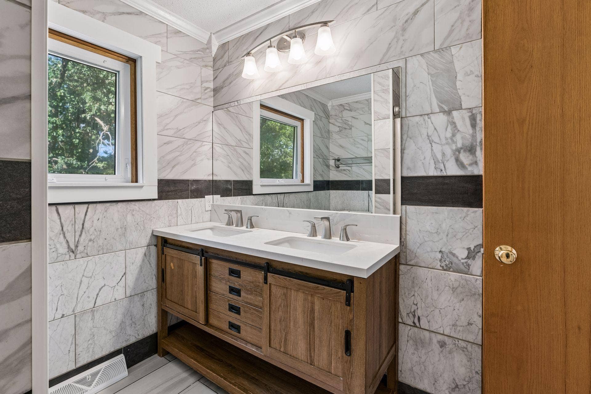 2841 Riviera Drive N, White Bear Lake, MN 55110 Double-sink vanity with drawers, sliding cabinet doors, and open lower storage.