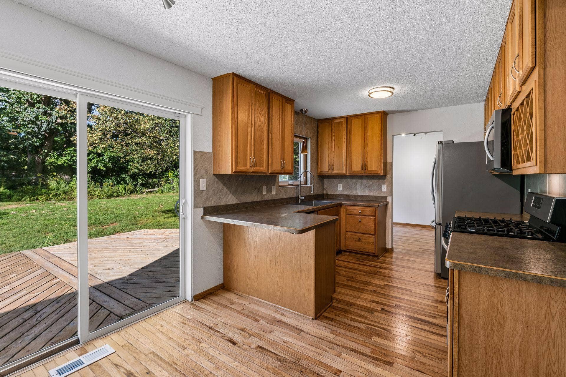 2841 Riviera Drive N, White Bear Lake, MN 55110 Sliding glass doors connect the kitchens casual dining area to the backyard deck.