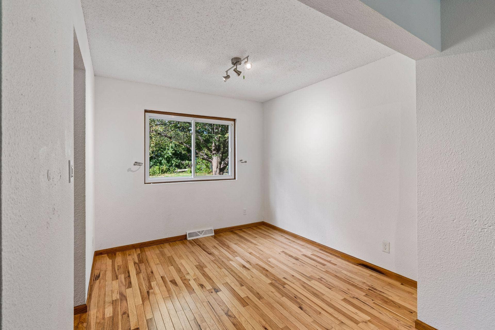 2841 Riviera Drive N, White Bear Lake, MN 55110 Dining area window frames views of backyard greenery.