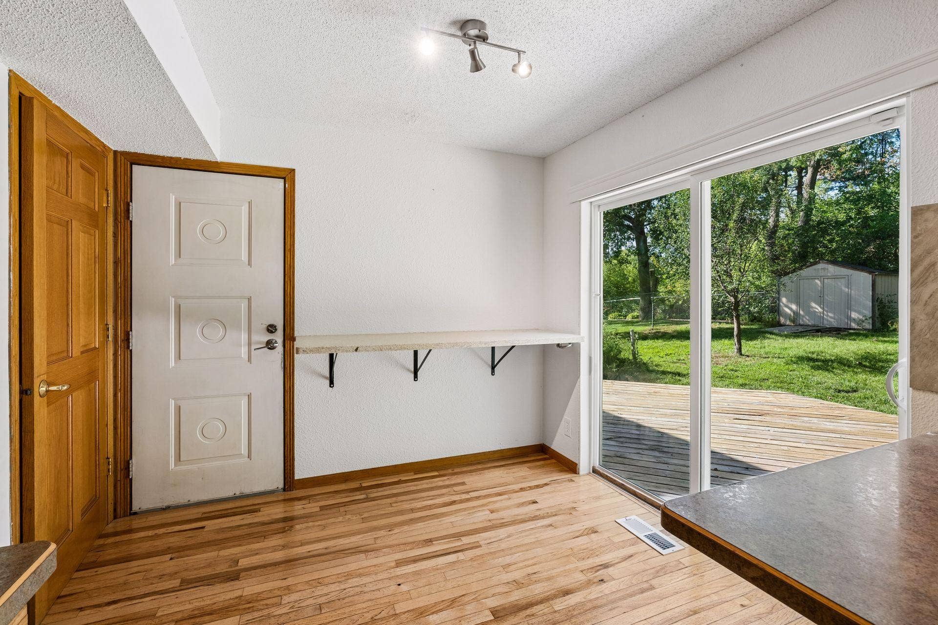 2841 Riviera Drive N, White Bear Lake, MN 55110 Breakfast area with a wall-mounted counter and views of the deck and yard.