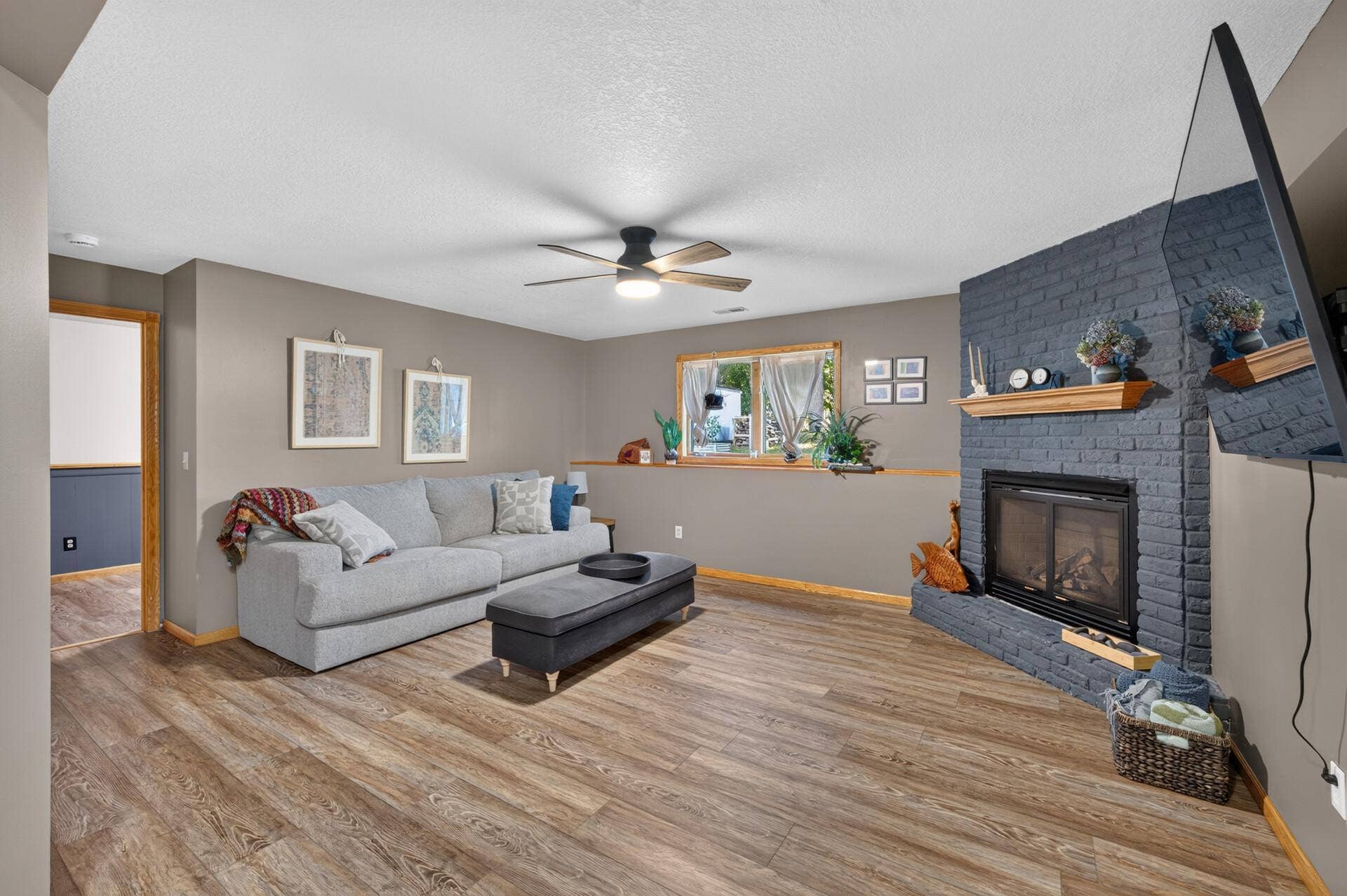 5956 Norway Pine Court, White Bear Lake, MN 55110 Cozy lower-level family room is anchored by a gas fireplace for added warmth and character.