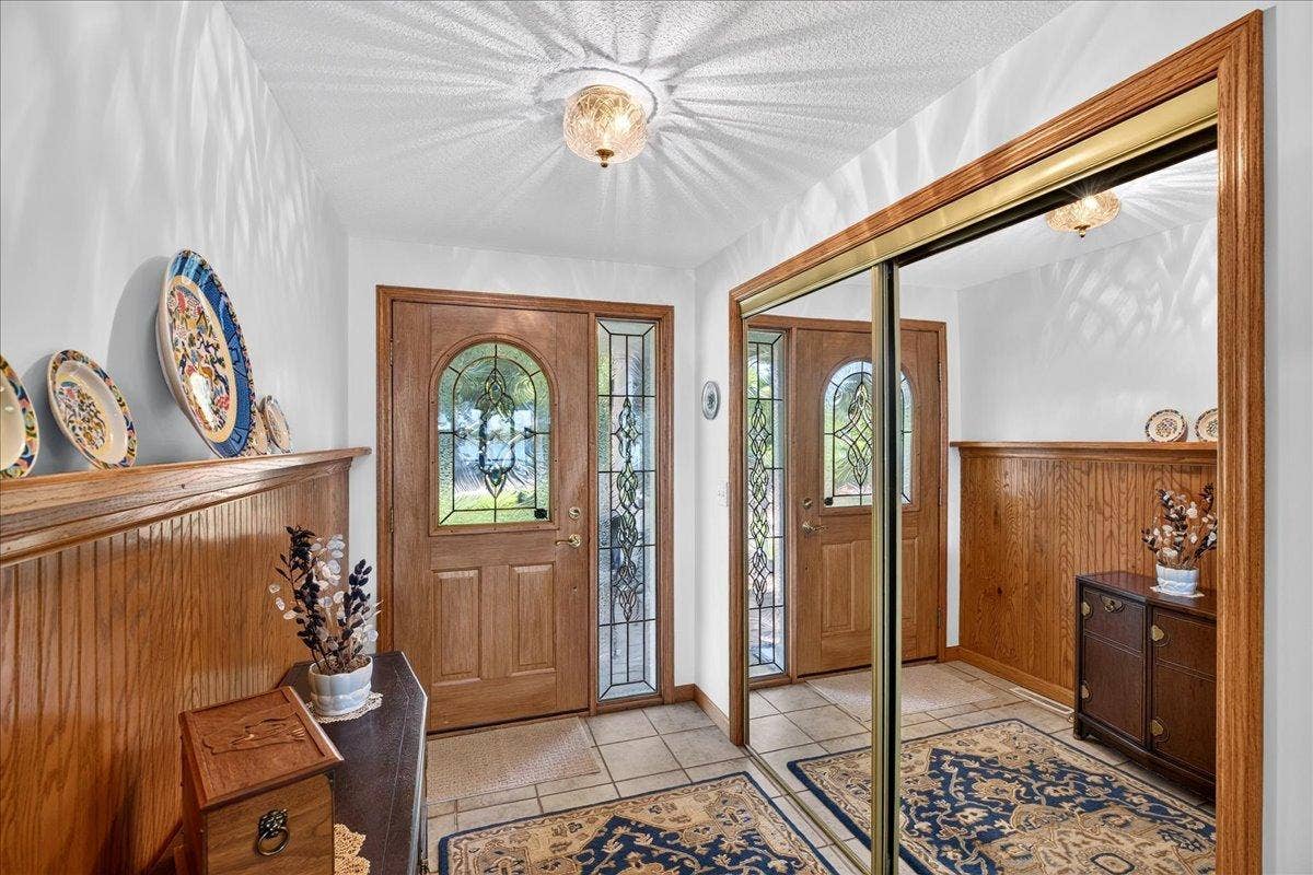 Welcoming Entry with Warm Woodwork at 12500 Melody Lane in Lindstrom MN