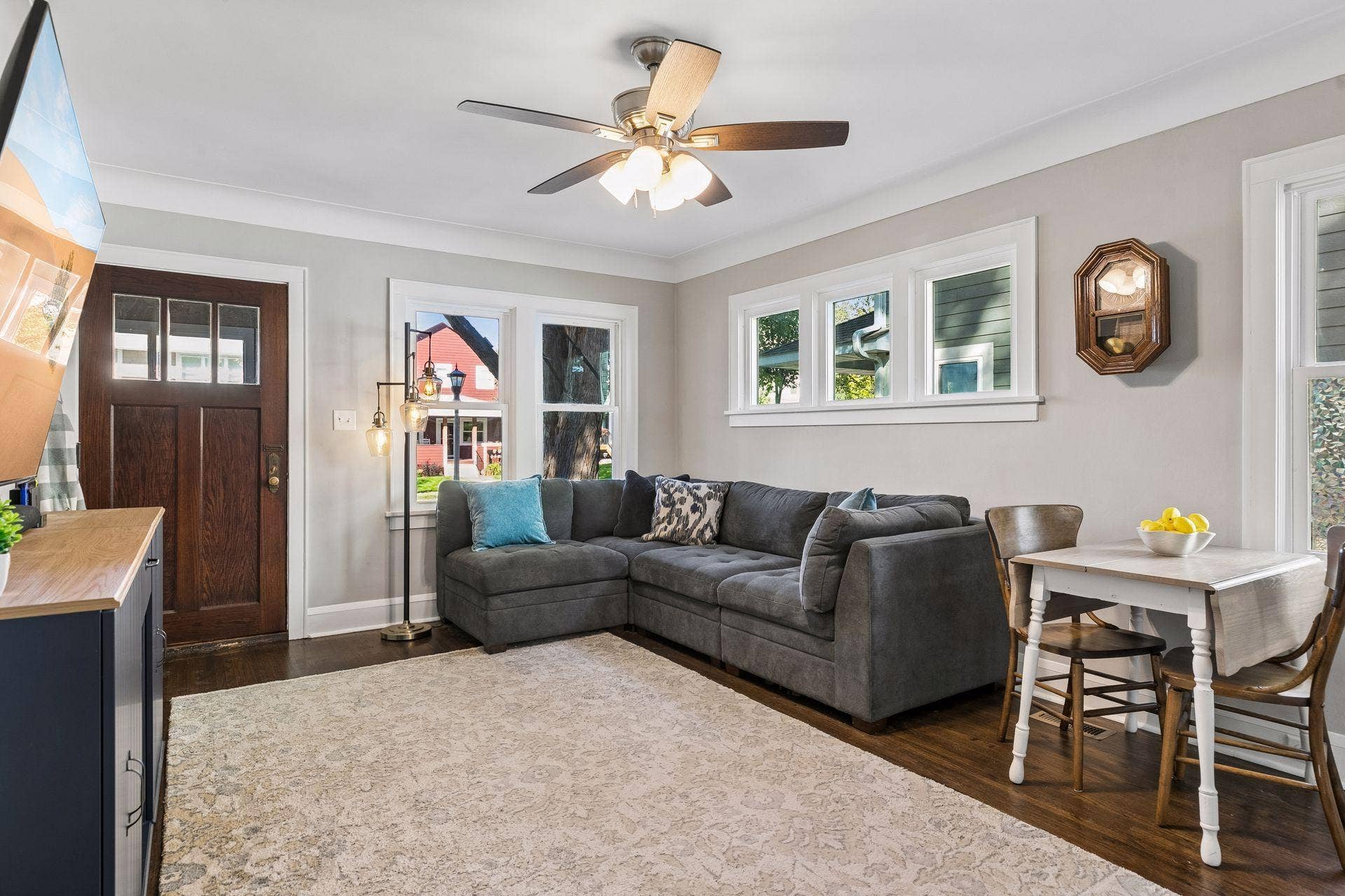 Bright main-level living room with hardwood floors, multiple windows, and plenty of natural light.
