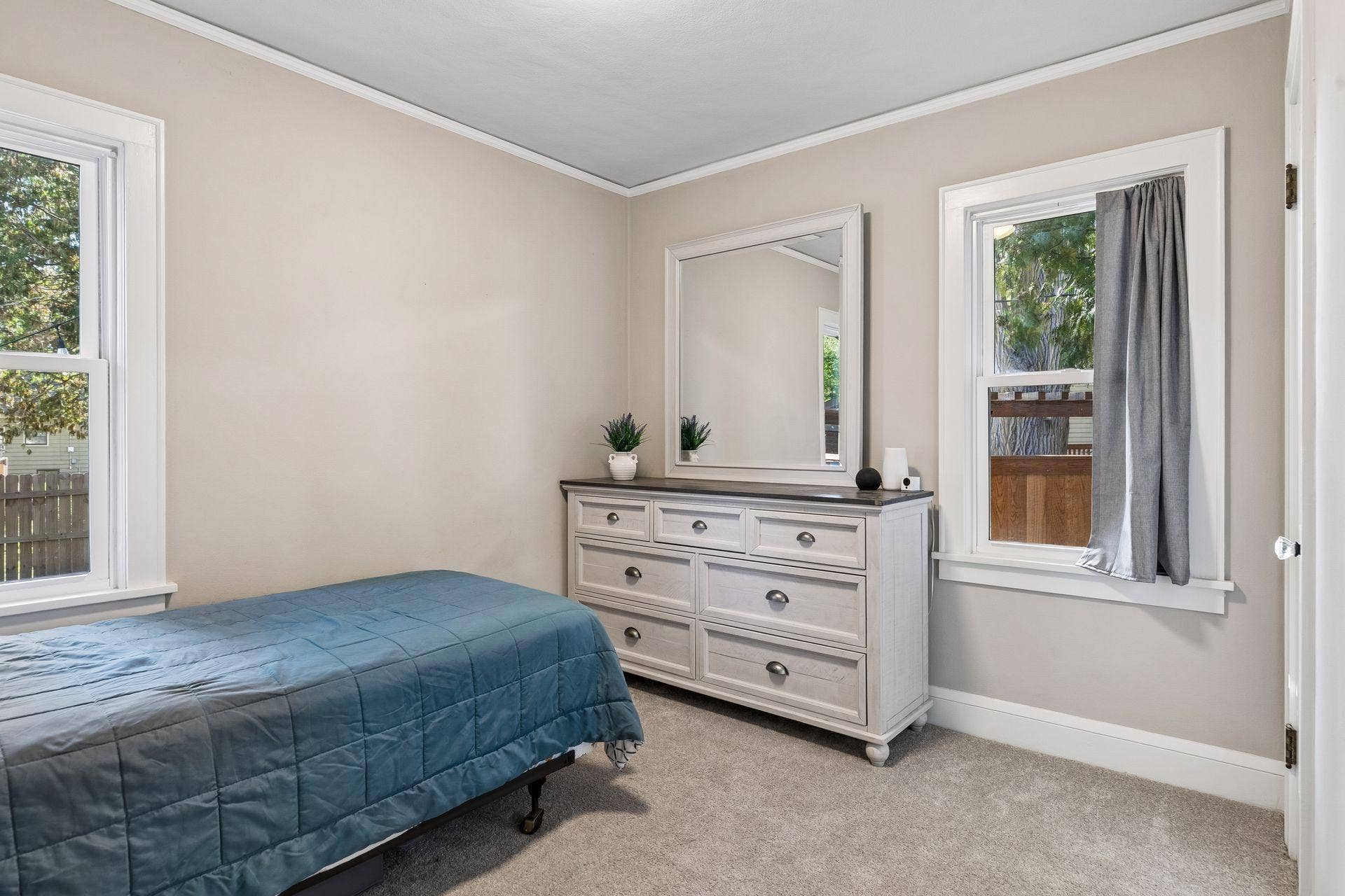 Second main-level bedroom with natural light, neutral finishes, and flexible space for a bedroom, guest room, or home office.