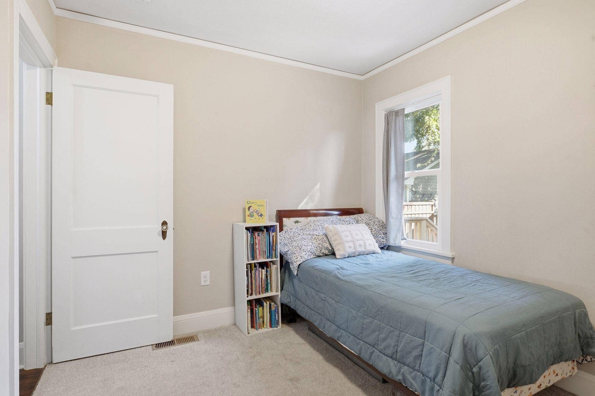 Additional view of the second main-level bedroom featuring natural light and a comfortable layout.