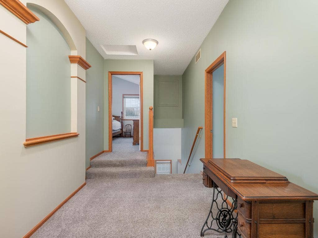 15344 64th Place N, Maple Grove, MN 55311 Upper level hallway continues to showcase the architectural detailing throughout the home!