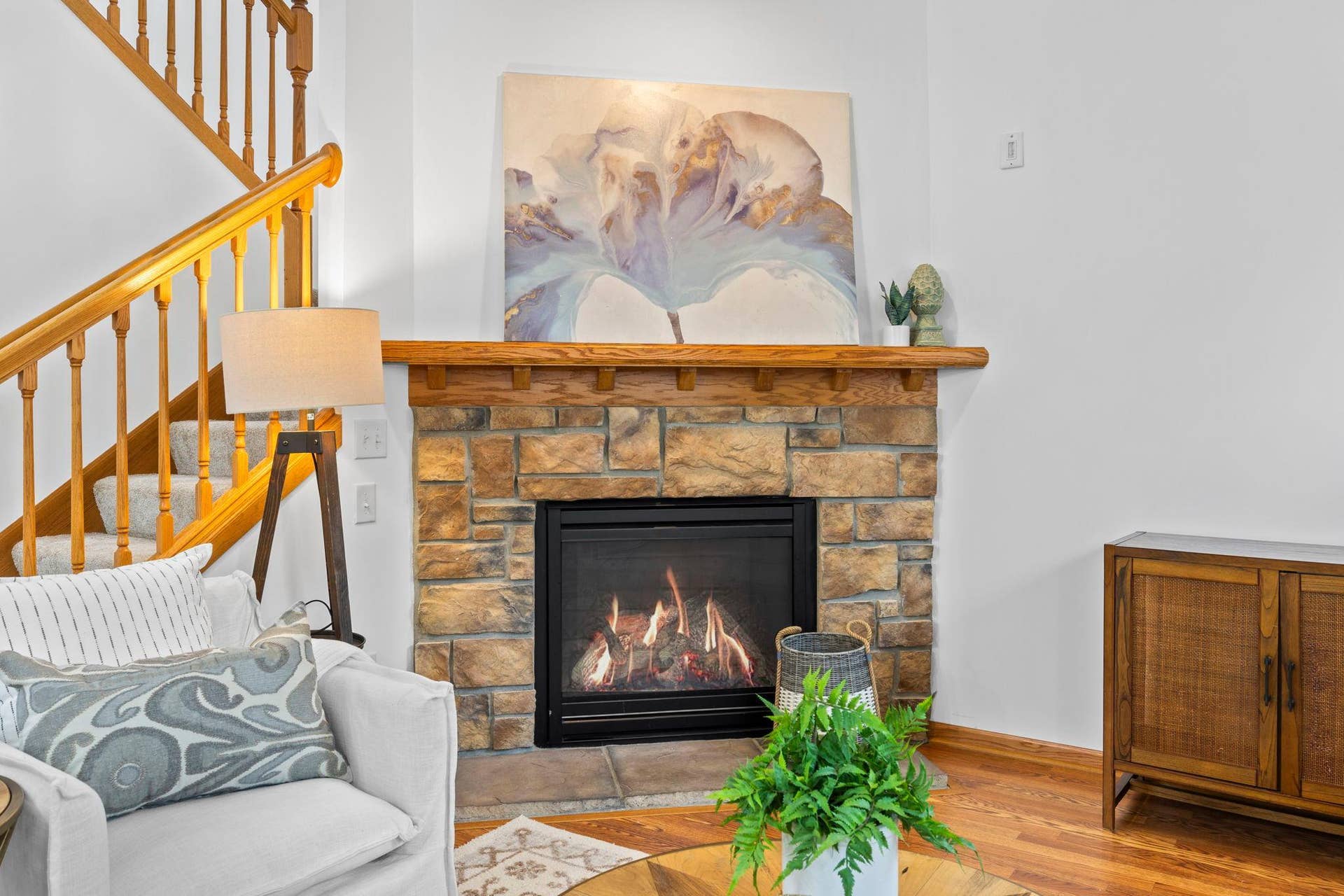1626 Woodlynn Avenue, #1, Maplewood, MN 55109 The adjacent living room is comfortable and light-filled, highlighted by a cozy gas-burning fireplace with a brick surround and wood mantel.