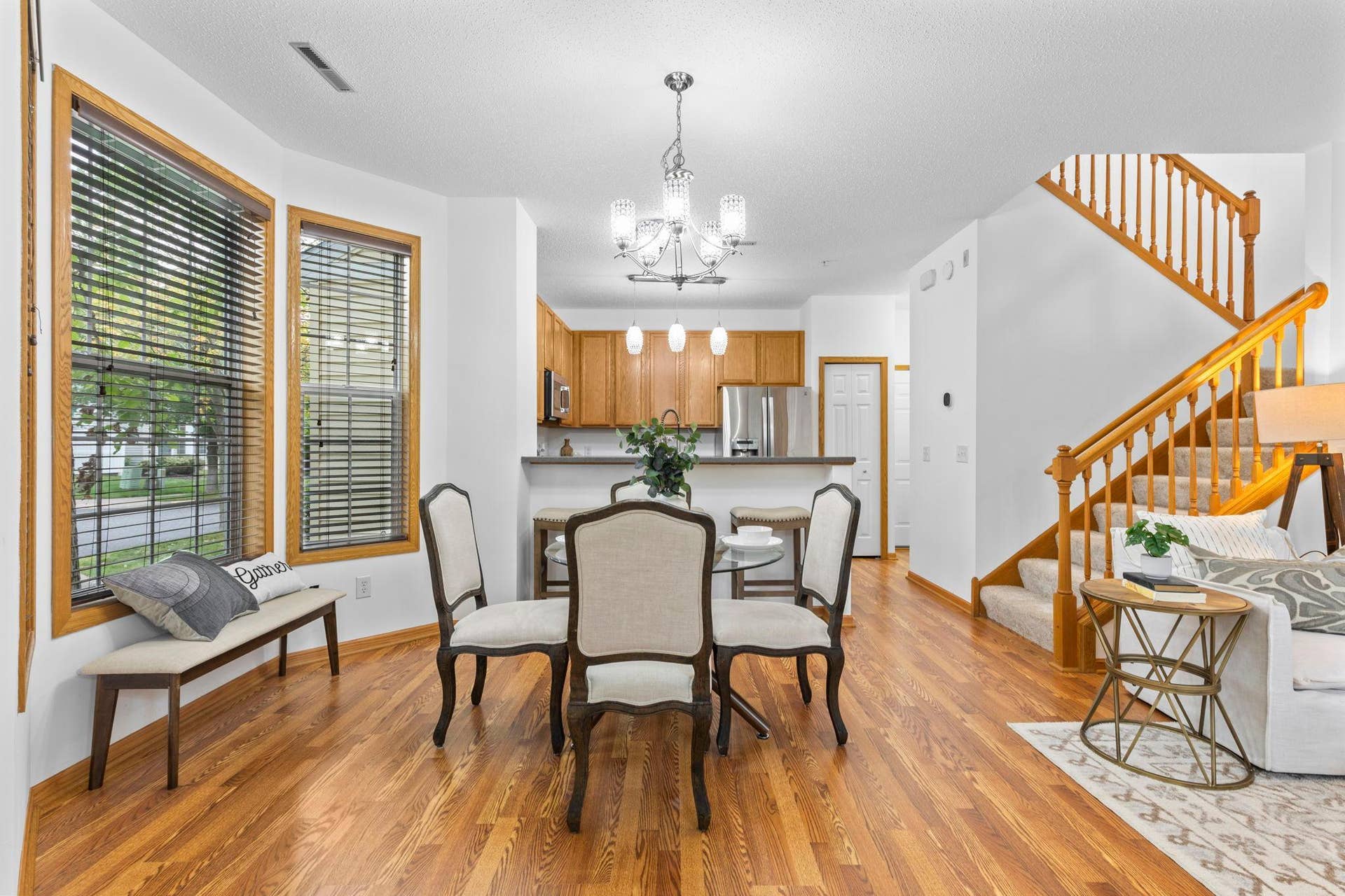 1626 Woodlynn Avenue, #1, Maplewood, MN 55109 Just beyond, the dining area features a chandelier and large windows that fill the space with natural light.