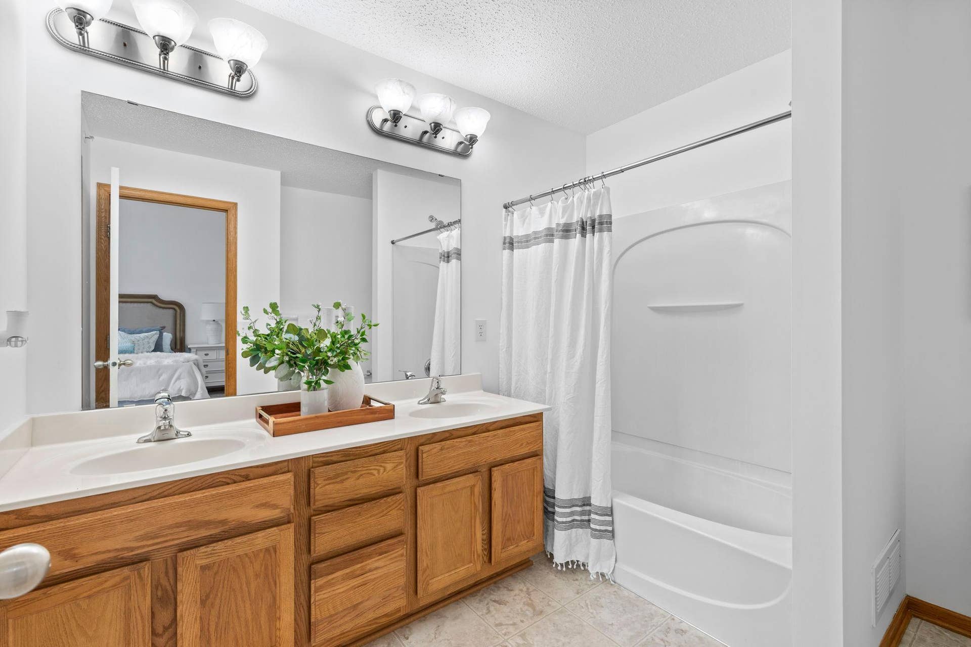 1626 Woodlynn Avenue, #1, Maplewood, MN 55109 The private ensuite bathroom features a double vanity, tub/shower combination, and access to a 6x6 walk-in closet.