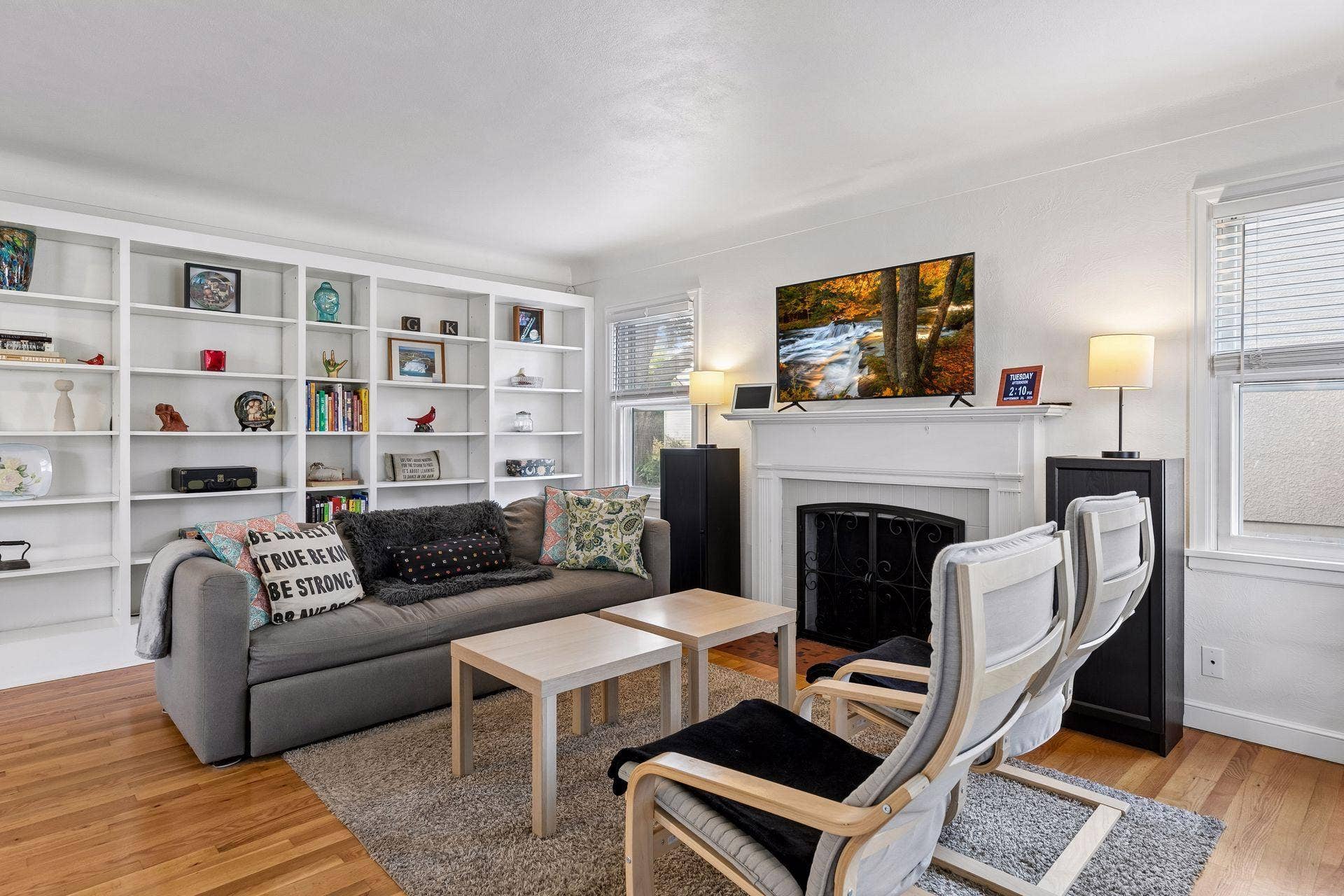 776 Parkview Avenue, 89, Saint Paul, MN 55117 Light-filled living room with beautiful hardwood floors, built-in shelving, and a decorative fireplace.