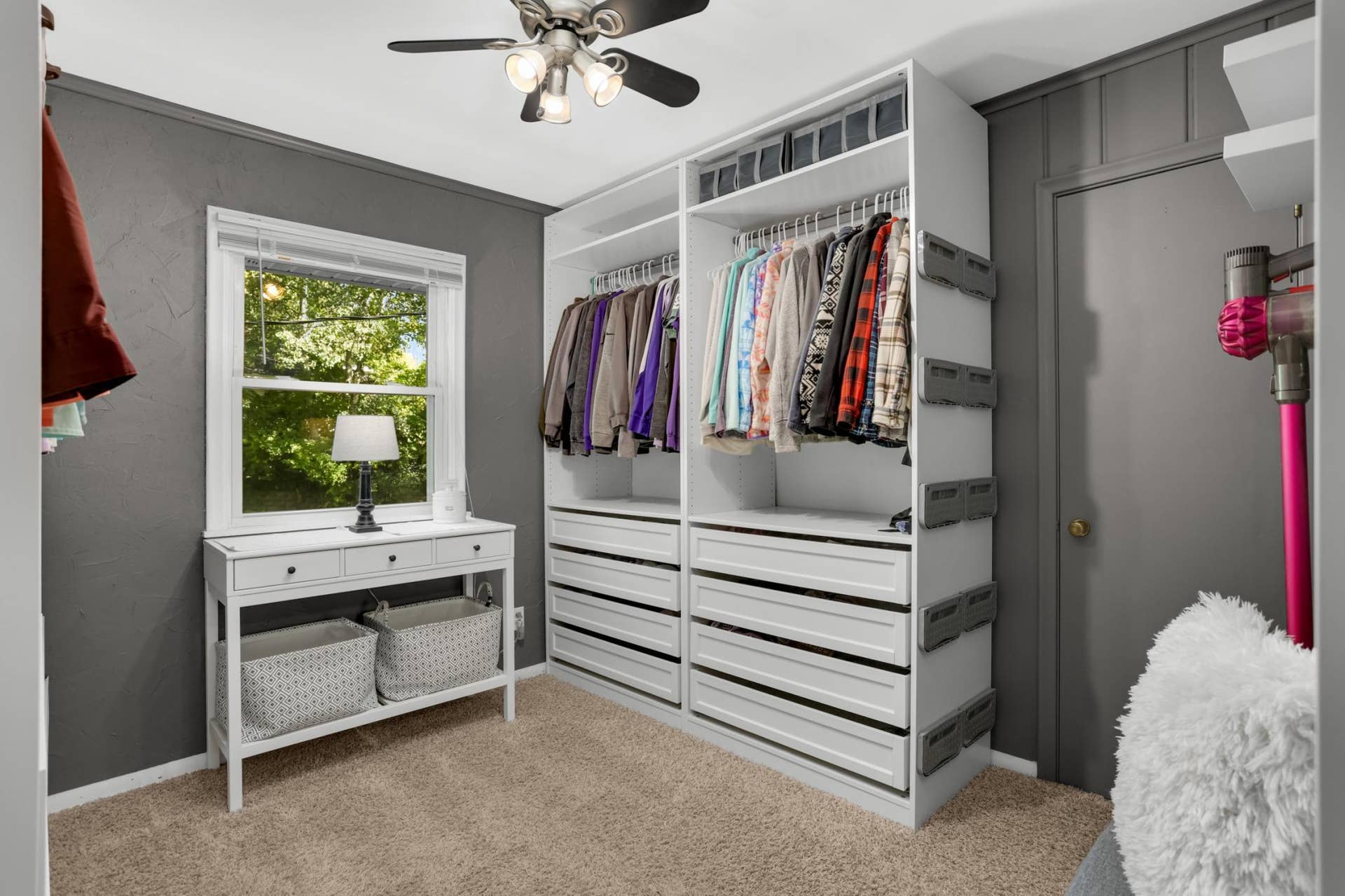 Main floor third bedroom currently used as walk in closet. All shelving is freestanding. Door to kitchen is behind this  wall unit
