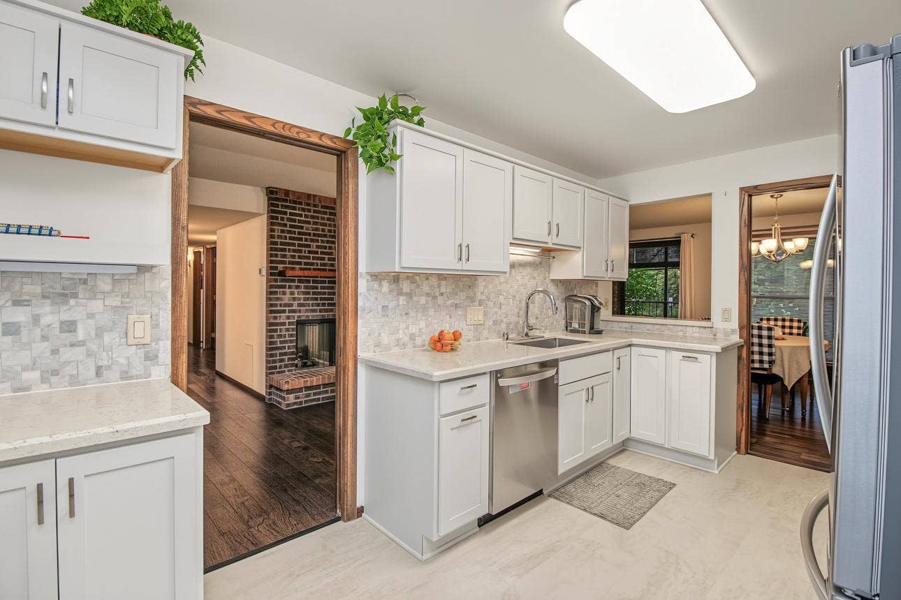 9700 Portland Avenue S, #128, Bloomington, MN 55420 Beautifully renovated kitchen features solid surface countertops, stainless appliances and tile floor and backsplash. This kitchen will impress!