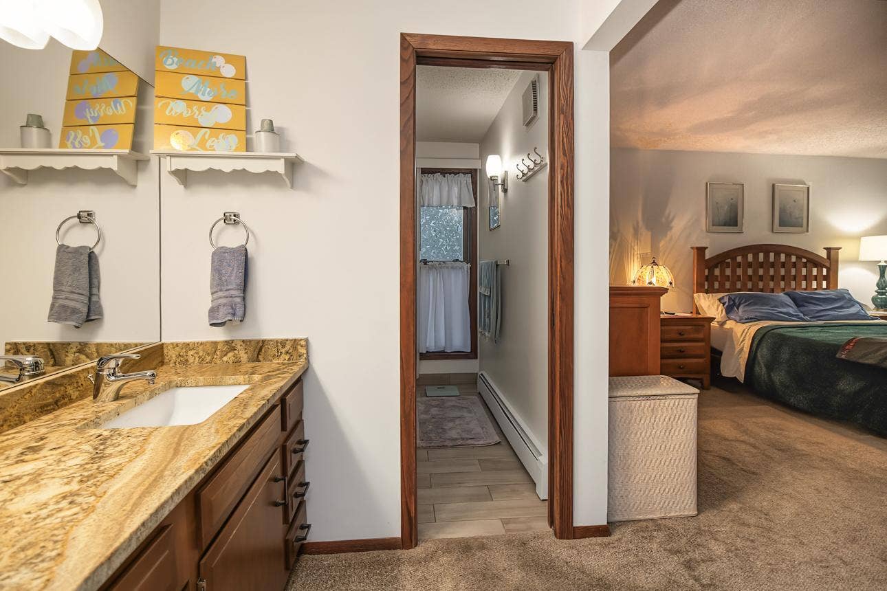 9700 Portland Avenue S, #128, Bloomington, MN 55420 Entry to fully renovated primary bath with tile walk-in shower.
