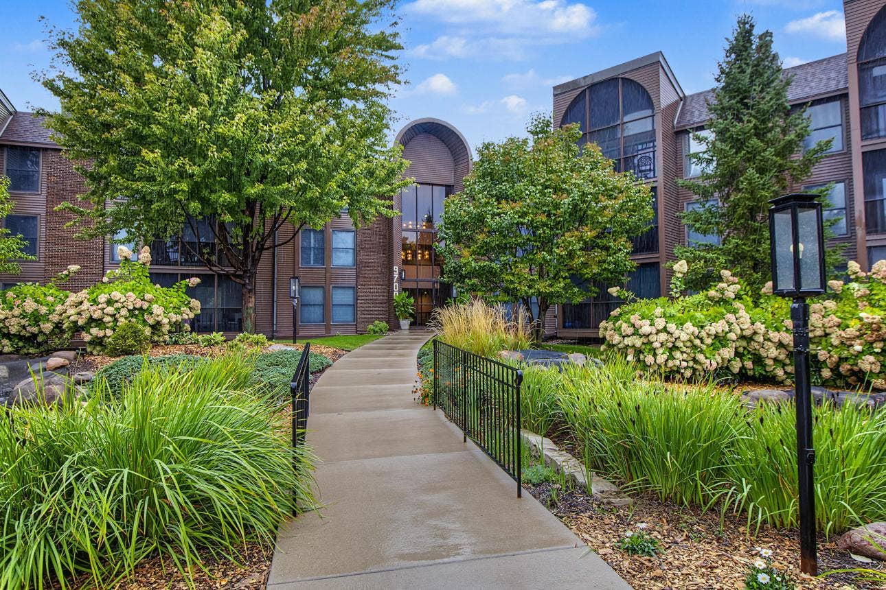 9700 Portland Avenue S, #128, Bloomington, MN 55420 Lush landscaping featuring gardens and ponds welcome visitors.