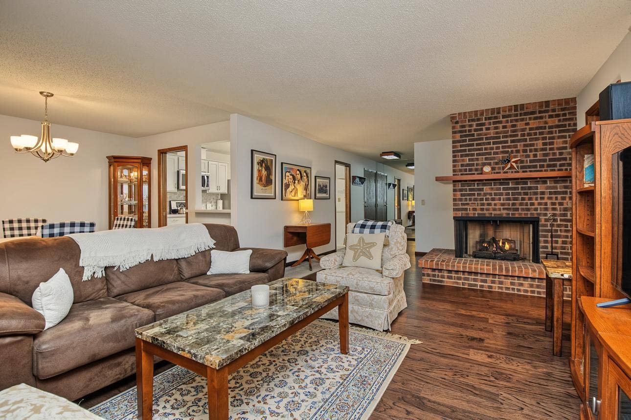 9700 Portland Avenue S, #128, Bloomington, MN 55420 Hardwood floors and impressive gas fireplace are features in the spacious living room.
