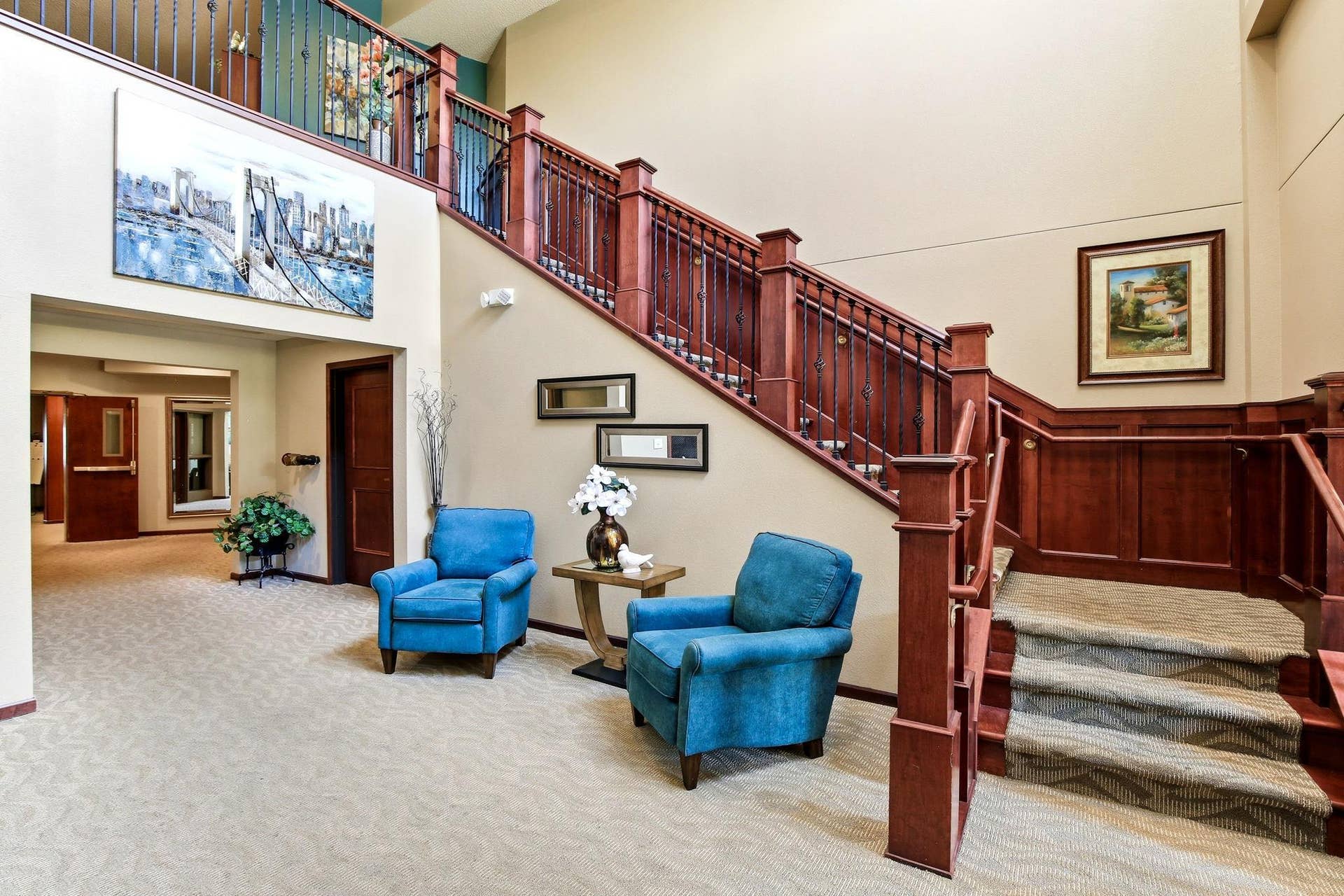 3800 85th Avenue N, #117, Brooklyn Park, MN 55443 The attractive open staircase at the building entry leads to the 2nd floor that has a small library and craft room.
