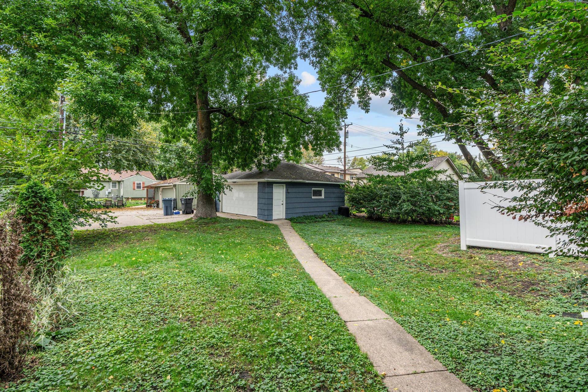 View of backyard looking at 2 stall garage.