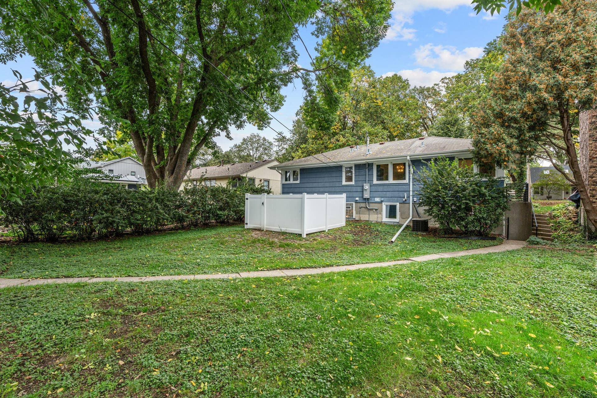 View of the backyard! Fenced in area is for the hot tub added in 2024 (included in sale).