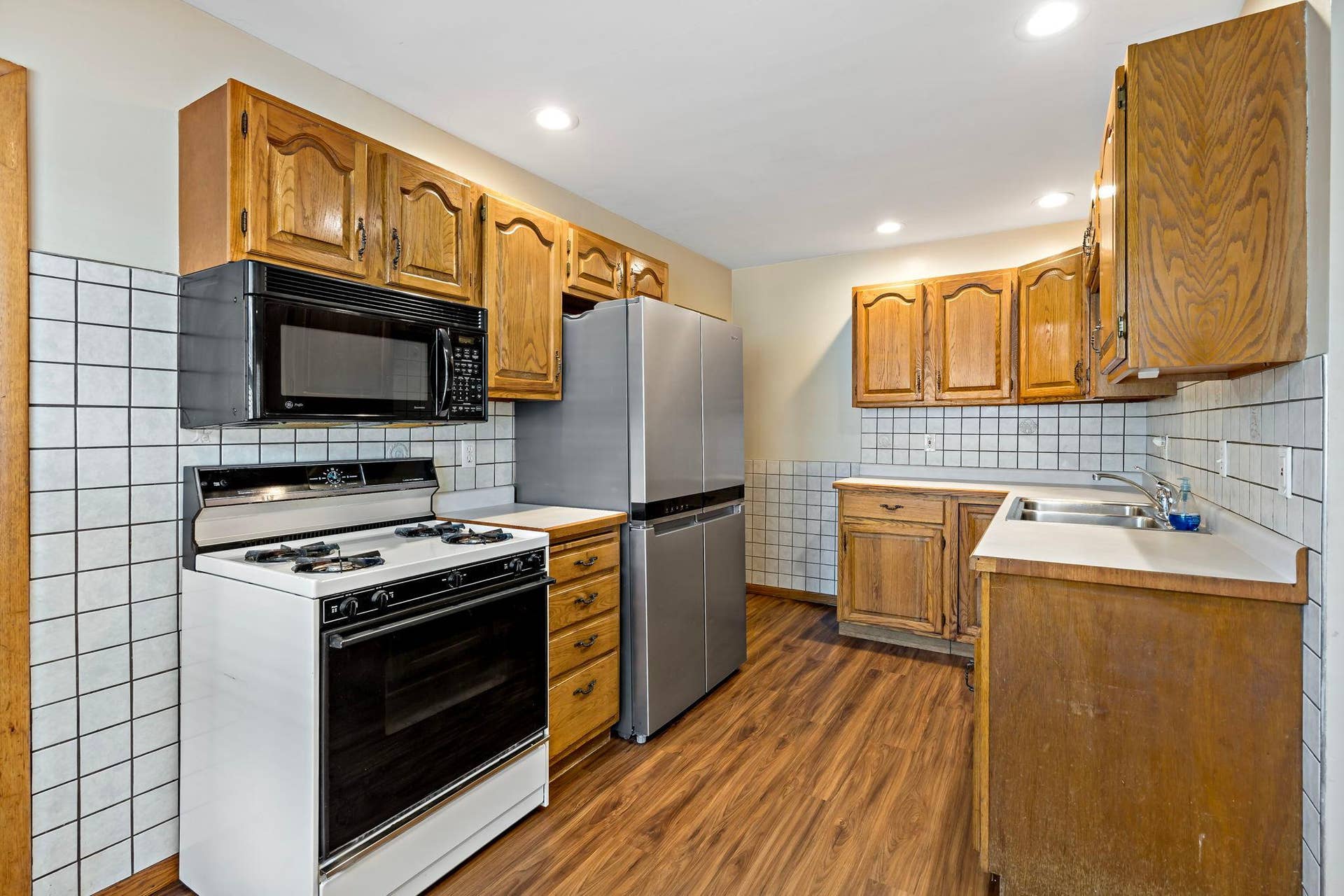 5749 Bloomington Avenue, 17, Minneapolis, MN 55417 Kitchen with gas range, stainless steel refrigerator and laminate flooring.