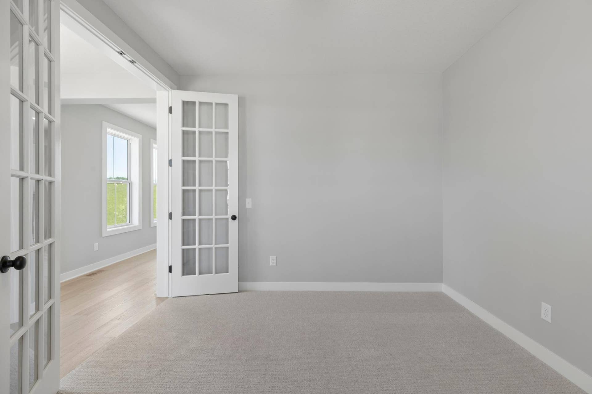 10409 Blackmoor Road, Woodbury, MN 55129 Beautiful french doors bring light from foyer windows into main level flex room (photo of actual listing).