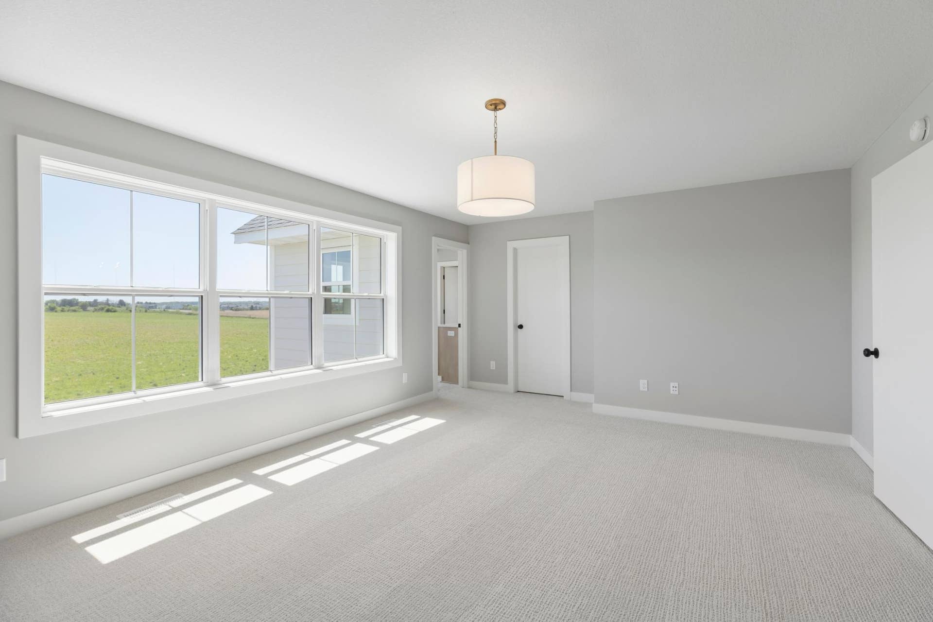 10409 Blackmoor Road, Woodbury, MN 55129 Spacious primary suite complete with dramatic double doors, private bath and walk-in closet (photo of actual listing).